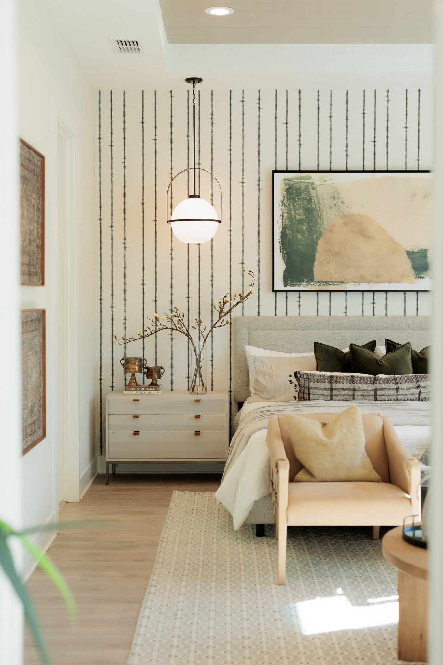Cozy bedroom with a reading chair and pendant light
