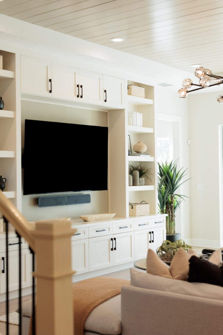 Living room with built-in shelving and a mounted TV